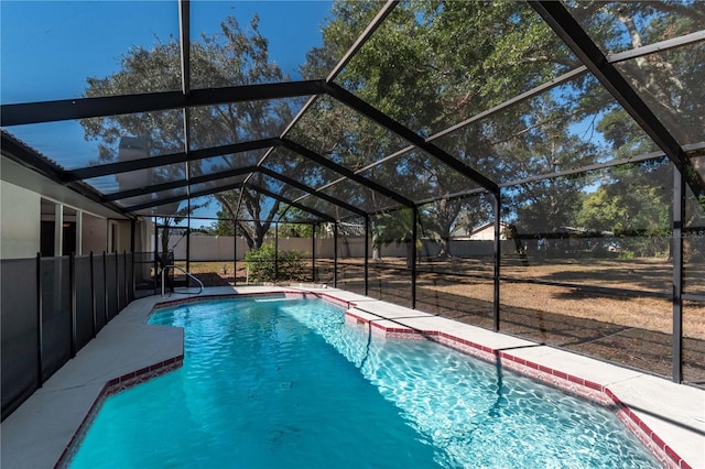 view of pool featuring glass enclosure