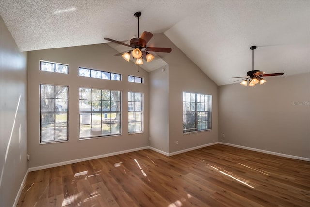 spare room with ceiling fan, dark hardwood / wood-style flooring, and high vaulted ceiling