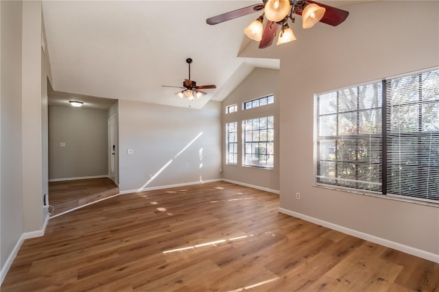 interior space with hardwood / wood-style flooring, ceiling fan, and high vaulted ceiling