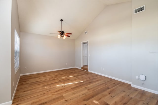 unfurnished room featuring ceiling fan, light wood-type flooring, and high vaulted ceiling