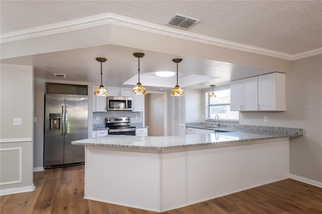 kitchen featuring kitchen peninsula, white cabinetry, sink, and appliances with stainless steel finishes