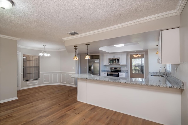 kitchen featuring kitchen peninsula, white cabinetry, sink, and appliances with stainless steel finishes