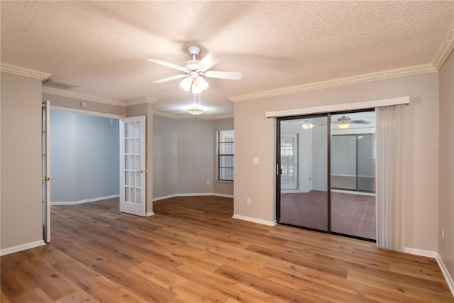 unfurnished room featuring french doors, light hardwood / wood-style flooring, a textured ceiling, and ornamental molding