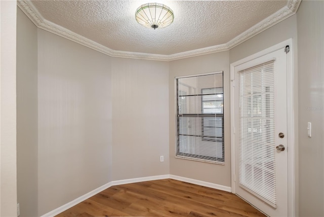 interior space with crown molding, a textured ceiling, and hardwood / wood-style flooring