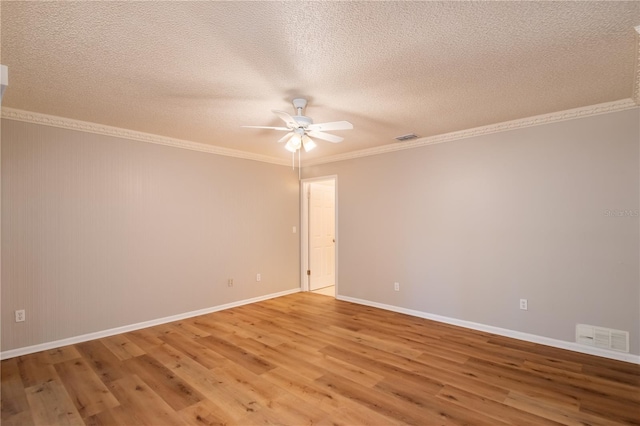 spare room featuring hardwood / wood-style floors, a textured ceiling, ceiling fan, and crown molding