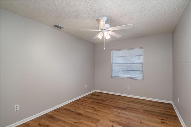 unfurnished room with wood-type flooring, a textured ceiling, and ceiling fan