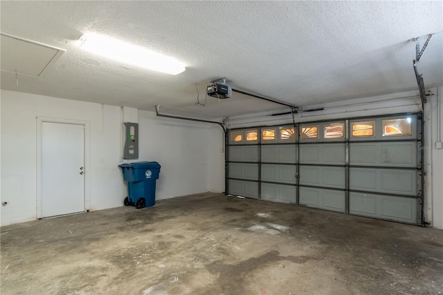 garage featuring electric panel and a garage door opener