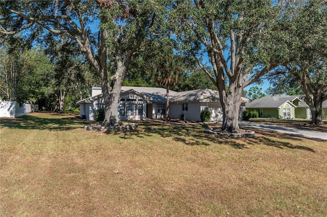 ranch-style home featuring a front yard