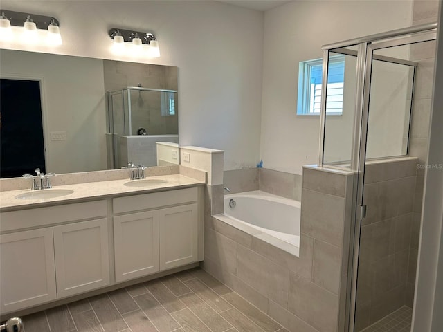 bathroom featuring separate shower and tub and vanity