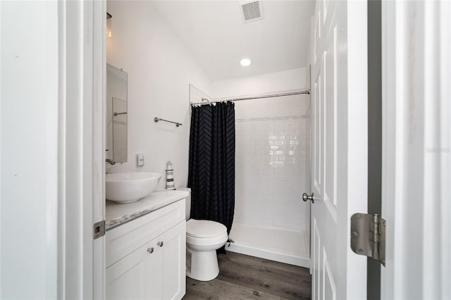 bathroom with hardwood / wood-style flooring, vanity, toilet, and a shower with shower curtain