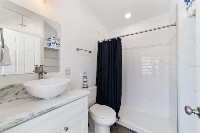 bathroom with vanity, a shower with shower curtain, and toilet