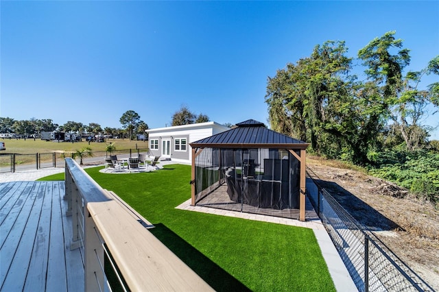 back of house with a fire pit, a gazebo, and a yard