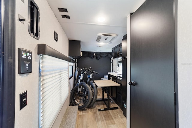 laundry area featuring light wood-type flooring