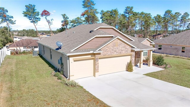 4313 SW 106th Pl, Ocala, FL 34476 - view of front of house featuring an attached garage, central AC unit, concrete driveway, stone siding, and stucco siding