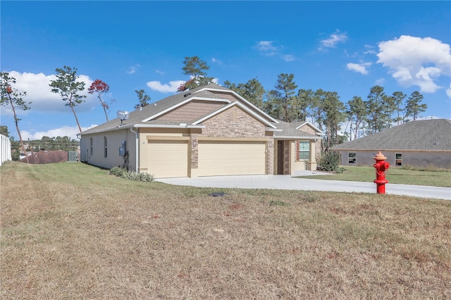 view of front of property with a garage and a front lawn