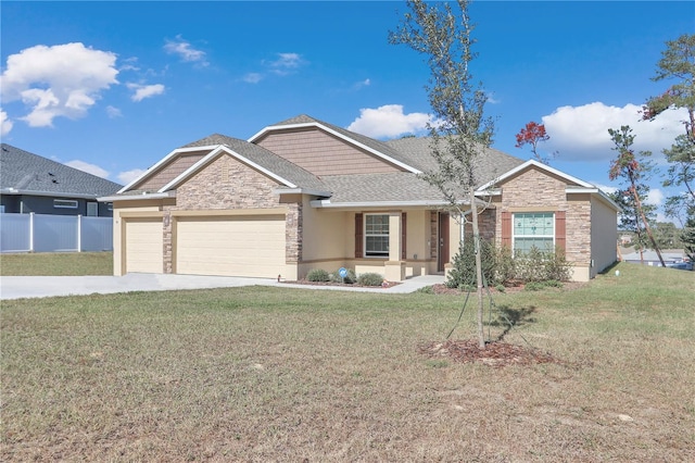 view of front of house featuring a garage and a front lawn