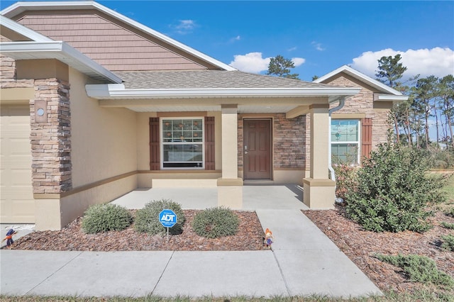 4313 SW 106th Pl, Ocala, FL 34476 - doorway to property with stone siding, roof with shingles, stucco siding, and covered porch