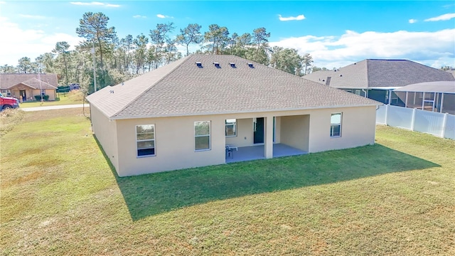 back of property featuring a lawn and a patio area