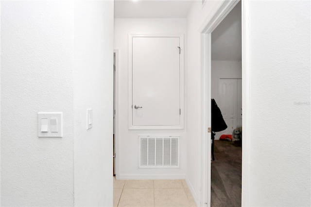 hall featuring light tile patterned floors