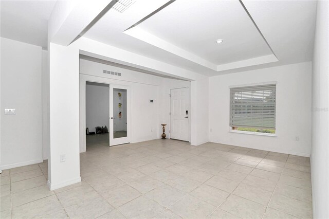 4313 SW 106th Pl, Ocala, FL 34476 - unfurnished room featuring a raised ceiling, light tile patterned flooring, and baseboards