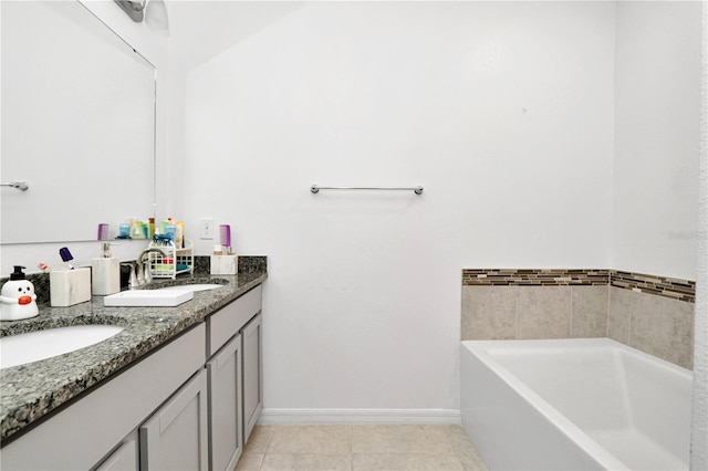 4313 SW 106th Pl, Ocala, FL 34476 - bathroom featuring double vanity, a garden tub, tile patterned floors, and baseboards
