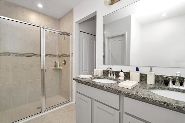 bathroom featuring tile patterned flooring, vanity, and an enclosed shower