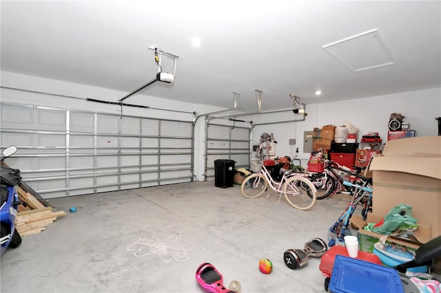 garage featuring electric panel and a garage door opener