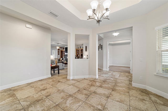 interior space featuring ceiling fan with notable chandelier