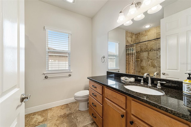 bathroom with toilet, vanity, and a shower with shower curtain