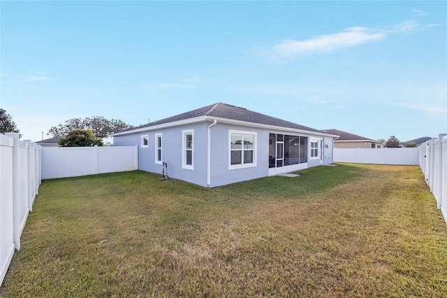 back of house featuring a sunroom and a yard