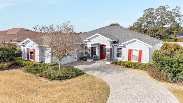 single story home featuring a front yard and a garage