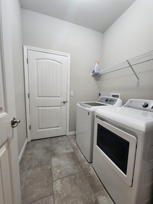 washroom with washer and dryer