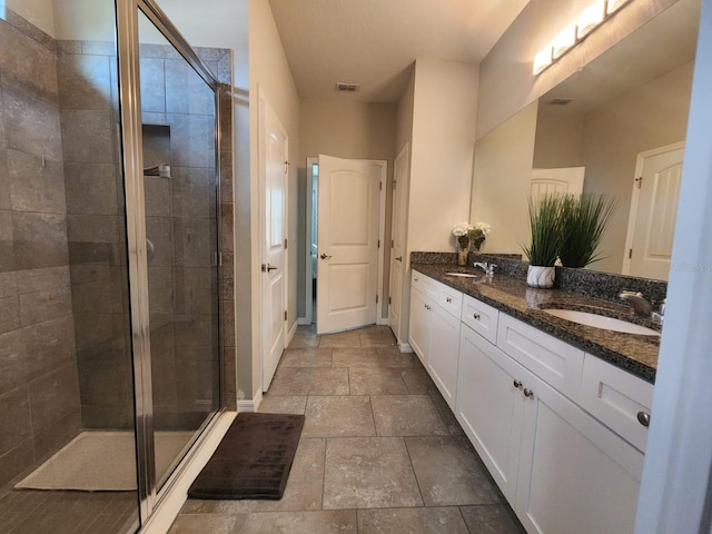 bathroom featuring vanity and an enclosed shower