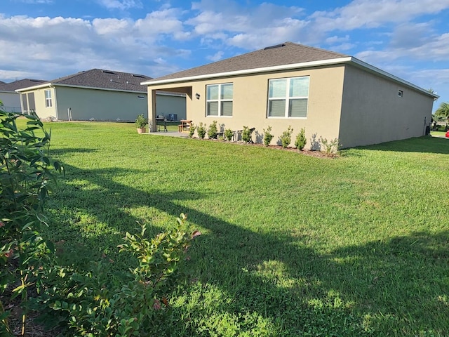 back of house featuring a yard and a patio