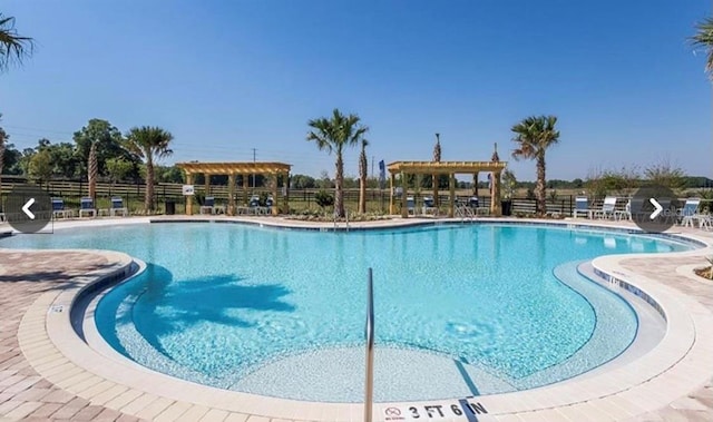 view of swimming pool featuring a patio