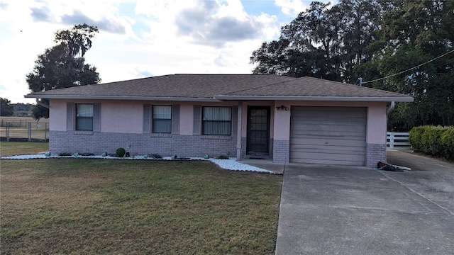 single story home with a front yard and a garage