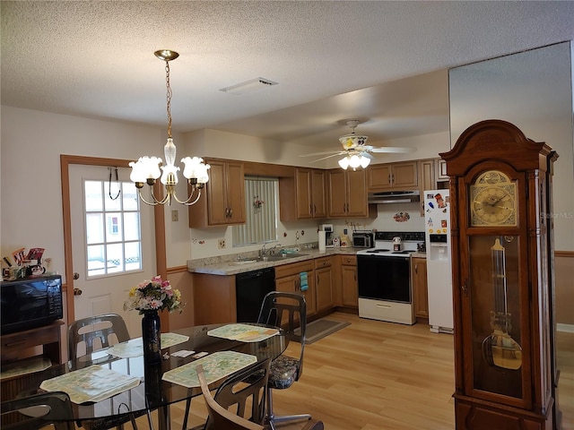 kitchen featuring black appliances, ceiling fan with notable chandelier, sink, light hardwood / wood-style flooring, and decorative light fixtures