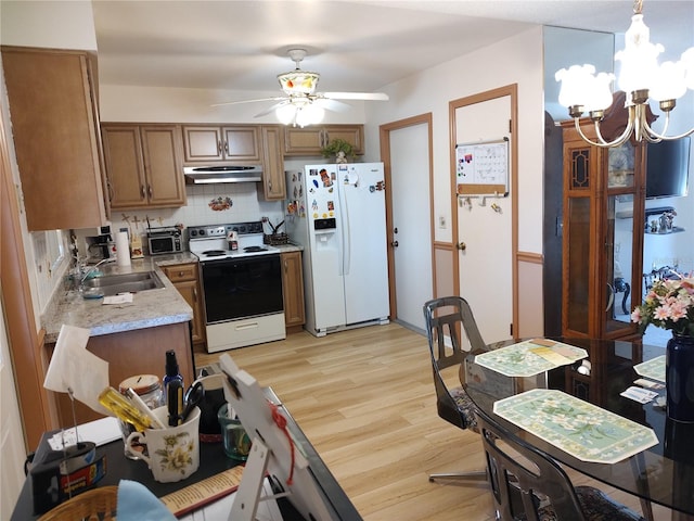 kitchen featuring decorative backsplash, ceiling fan with notable chandelier, white appliances, sink, and light hardwood / wood-style floors