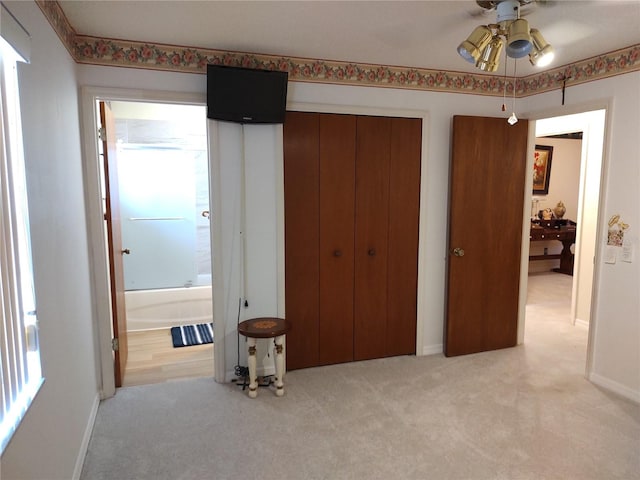 bedroom featuring light carpet, a closet, and ceiling fan