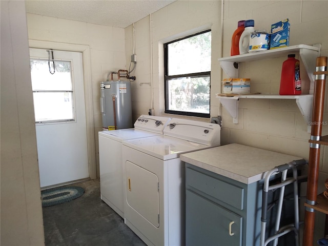 washroom featuring independent washer and dryer, a textured ceiling, and water heater