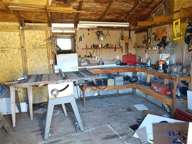 miscellaneous room featuring a workshop area and lofted ceiling