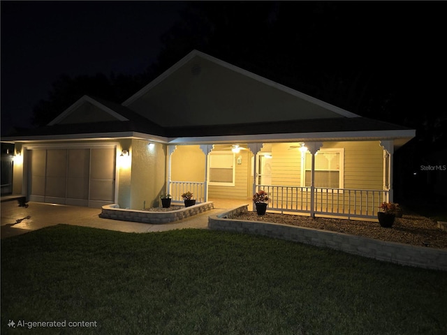 back house at twilight featuring a porch, a garage, and a yard