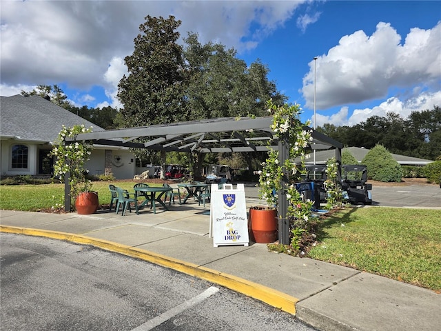 view of vehicle parking with a yard