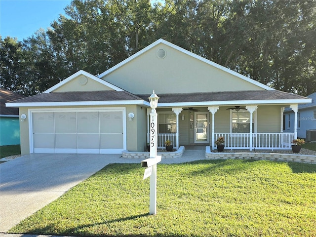 view of front of property with a porch, a garage, central AC unit, and a front yard