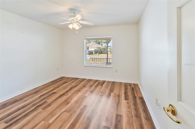 unfurnished room with hardwood / wood-style flooring and ceiling fan