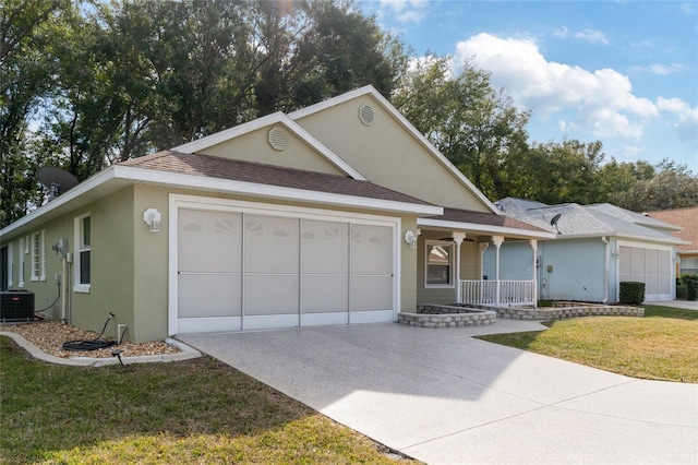 view of front of home featuring a porch, a garage, central AC, and a front yard