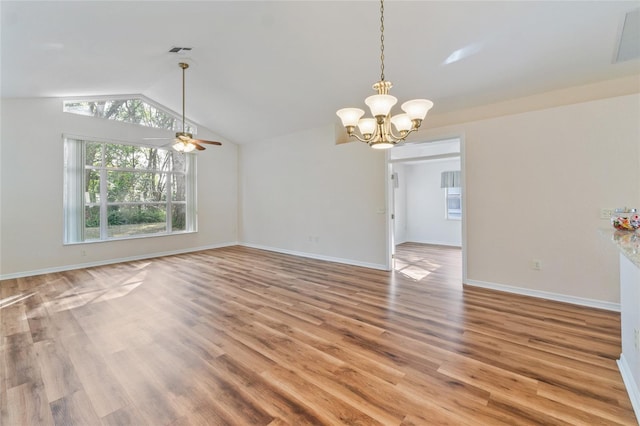 interior space featuring lofted ceiling, ceiling fan with notable chandelier, and wood-type flooring