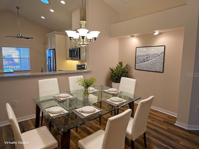 dining space featuring dark wood-type flooring, an inviting chandelier, and vaulted ceiling