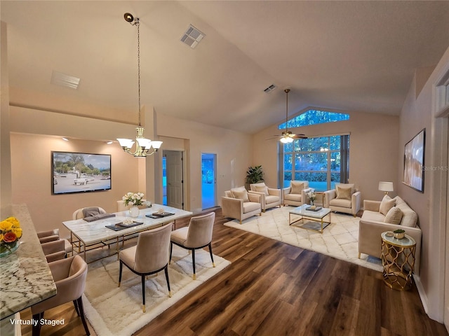 dining space with hardwood / wood-style flooring, lofted ceiling, and a notable chandelier