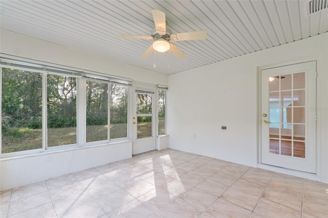 unfurnished sunroom featuring ceiling fan